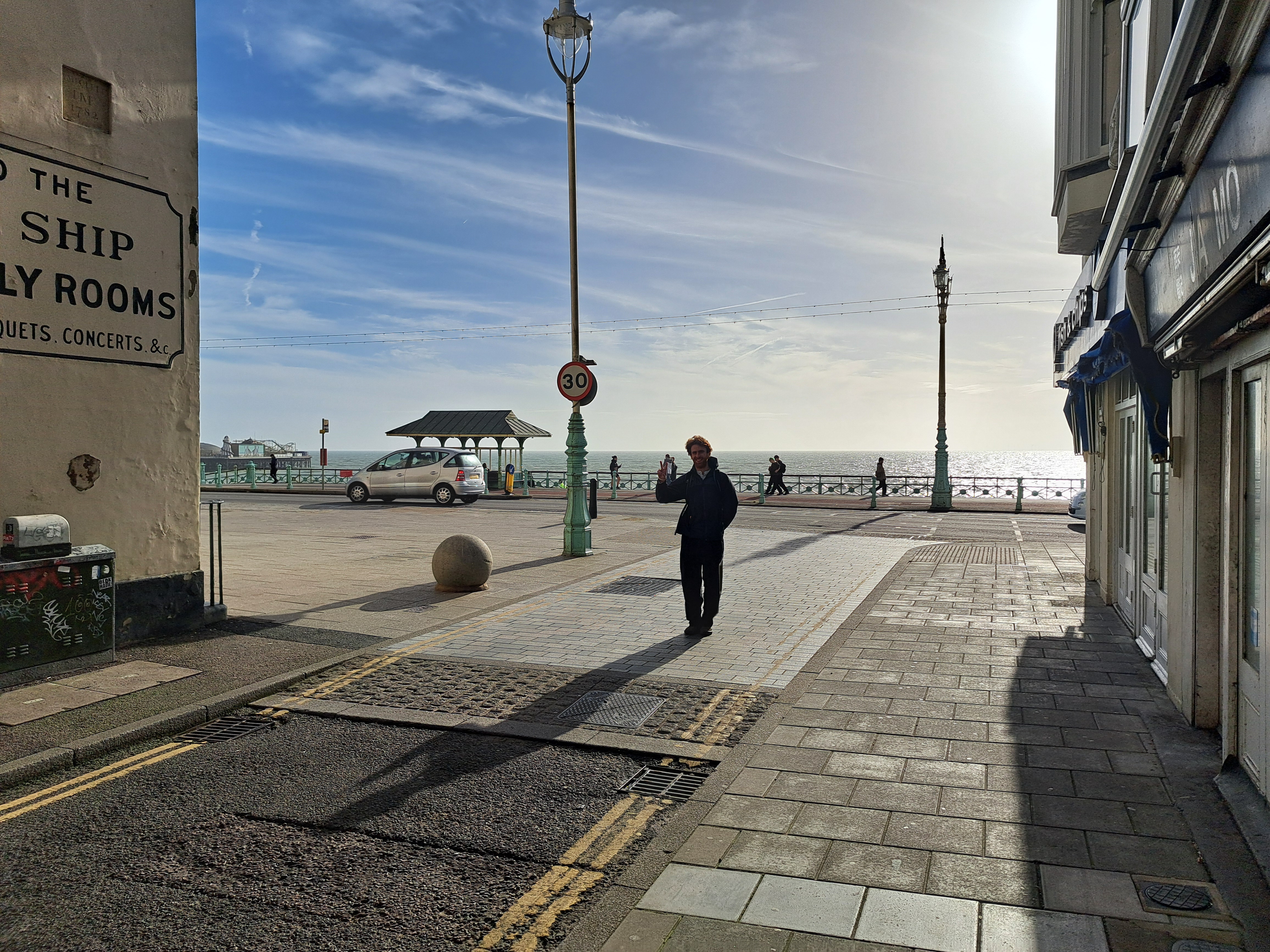 author standing in Brighton making peace sign